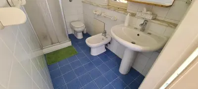 a bathroom with a sink and a toilet and a sink at I Sollazzi in Palermo