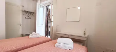 a white room with two beds and a mirror at Appartamento Salinas Palermo in Palermo