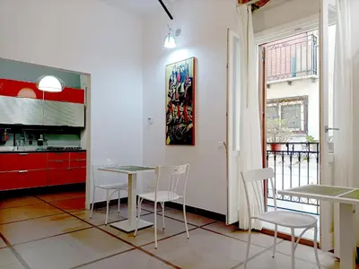 a kitchen with a table and chairs in a room at Appartamento Salinas Palermo in Palermo
