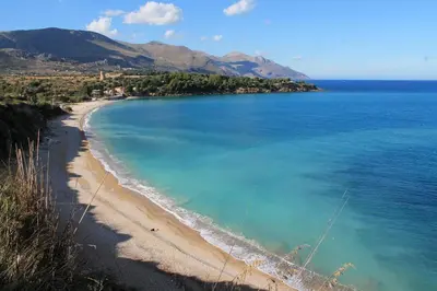 a view of a beach and the ocean at sicilian rustic in Scopello