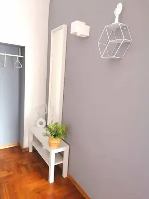 a room with a mirror and a table with a plant at Historic Centre - Apartment at Foro Borbonico in Palermo