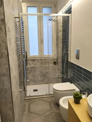 a bathroom with a shower and a toilet and a sink at Al Massimo apartment in Palermo