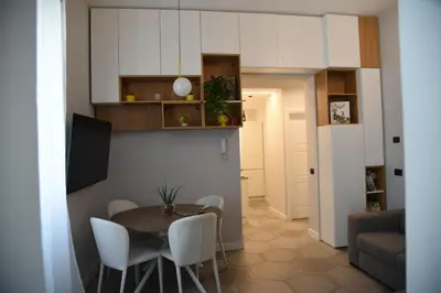 a kitchen and dining room with a table and chairs at Al Massimo apartment in Palermo