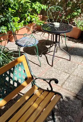 a table and two chairs and a table and a table and a bench at Room in Villa Galletti Inguaggiato in Bagheria