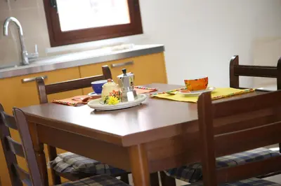 a wooden table with a plate of food on it at King's Residence in Balestrate