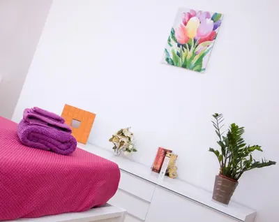 a bedroom with a pink blanket on a bed at King's Residence in Balestrate