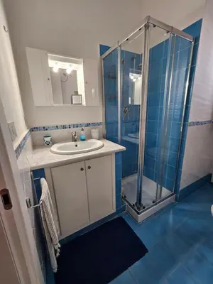 a bathroom with a sink and a shower at IsolaHome in Isola delle Femmine