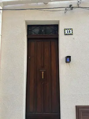 a wooden door on the side of a building at Corleone Home in Corleone
