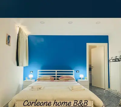 a bedroom with a blue wall and a bed at Corleone Home in Corleone