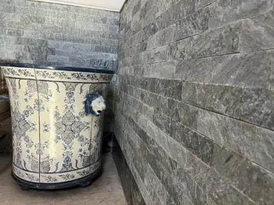 a large bucket sitting next to a brick wall at A CASA DEL CONSOLE in Mondello