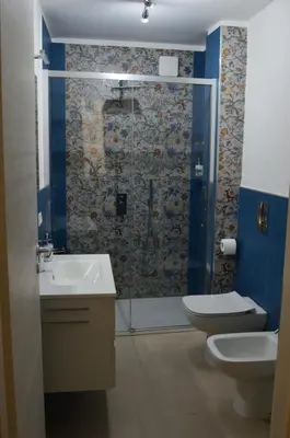 a bathroom with a shower and a toilet and a sink at Futtitinni Home casamia in Palermo