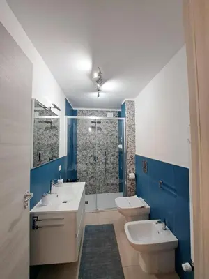 a bathroom with two sinks and a toilet and a shower at Futtitinni Home casamia in Palermo