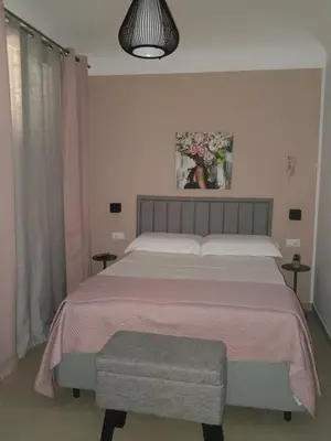 a bedroom with a large bed with a pink blanket at Futtitinni Home casamia in Palermo