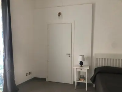 a white door in a room with a lamp on a table at City Center Apartment da FeLù in Palermo