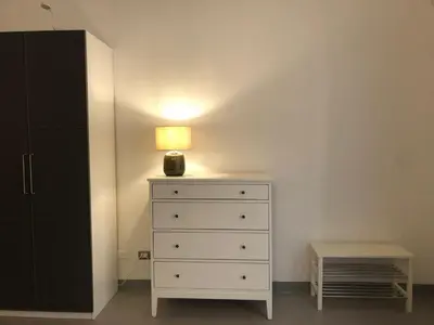 a white dresser with a lamp on top of it at City Center Apartment da FeLù in Palermo