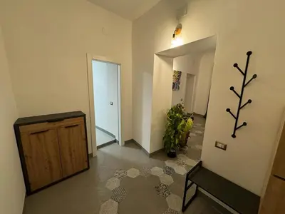 a room with a hallway with a wooden cabinet and a door at City Center Apartment da FeLù in Palermo