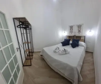 a bedroom with a bed with shoes and a ladder at Il quaRtetto apartment in Palermo