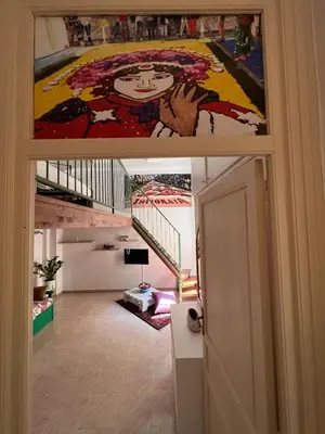 a view from the hallway of a house with a painting at 