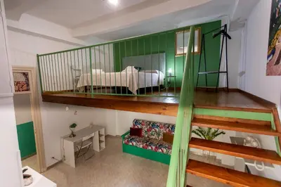 a room with a bed on a green wall at 