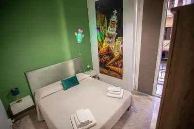 a bedroom with a white bed in a green wall at 