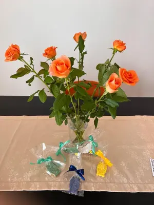 a vase filled with orange roses on a table at 