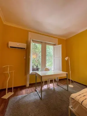 a yellow room with a table in front of a window at MATTI X 2 in Palermo
