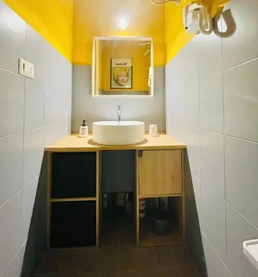 a bathroom with a white sink and a yellow ceiling at MATTI X 2 in Palermo