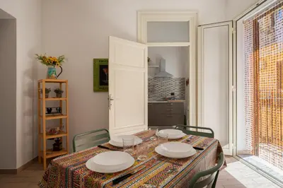 a dining room with a table with plates on it at Casa Ferrito - Porticello in Porticello