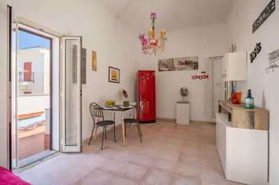 a kitchen and dining room with a table and a refrigerator at Casa Ferrito - Porticello in Porticello