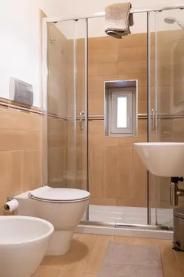 a bathroom with a shower and a toilet and a sink at Four Luxury Apartment in Palermo
