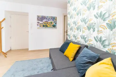 a living room with a gray couch and yellow pillows at Four Luxury Apartment in Palermo
