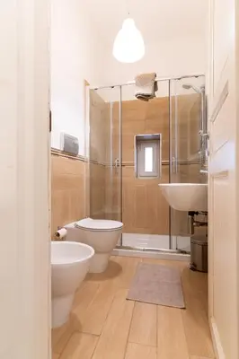a bathroom with a shower and a toilet and a sink at Four Luxury Apartment in Palermo