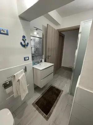 a white bathroom with a sink and a toilet at Tampasiando in Cinisi