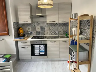 a kitchen with a sink and a stove top oven at Tampasiando in Cinisi