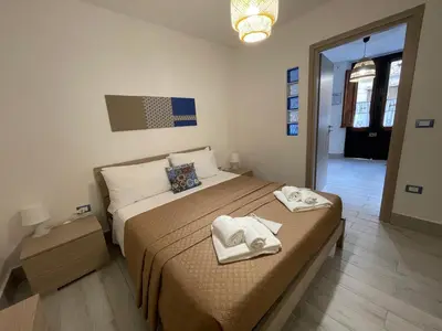a bedroom with a large bed with towels on it at Tampasiando in Cinisi