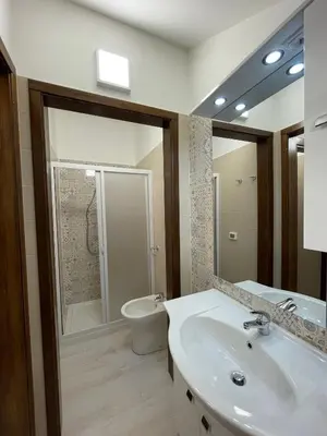 a bathroom with a sink and a toilet and a mirror at Civico 356 in Castellammare del Golfo