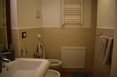 a bathroom with a white sink and a toilet at Casa Selinunte in Palermo