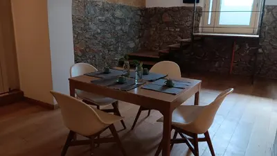 a dining room with a wooden table and chairs at Casa Selinunte in Palermo