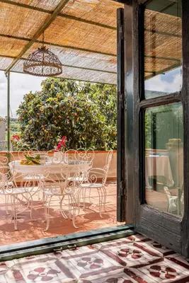a view of a patio with a table and chairs at Villa surrounded by Nature overlooking the Sea - Cefalù in Lascari