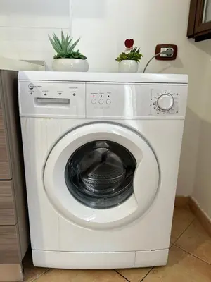 a washing machine with two plants on top of it at A casa ru zu Nino in Capaci