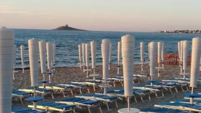 a group of blue chairs and chairs on a beach at A casa ru zu Nino in Capaci