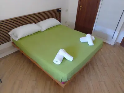 a bed with two pillows on it with two sticks at Antadia in Palermo