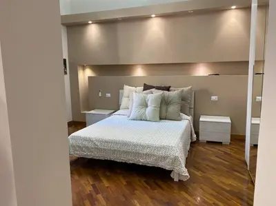 a bedroom with a large bed with white sheets and pillows at DEMMA LUXURY HOME in Palermo