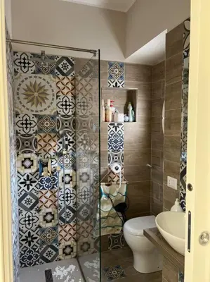 a bathroom with a shower with a toilet and a sink at DEMMA LUXURY HOME in Palermo