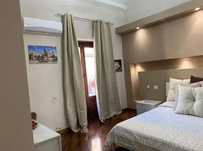 a bedroom with a large bed and a window at DEMMA LUXURY HOME in Palermo