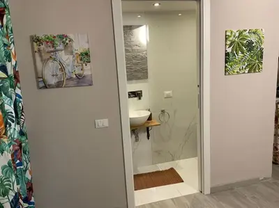 a bathroom with a shower and a sink and a mirror at Demma' s DIAMOND in Palermo