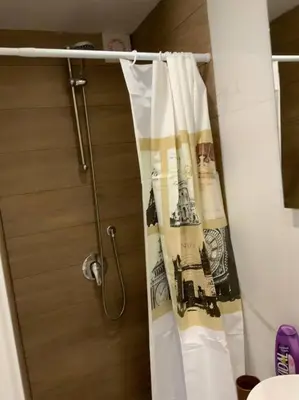 a shower curtain in a bathroom next to a showeroser at Demma' s DIAMOND in Palermo