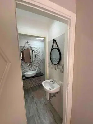 a bathroom with a sink and a mirror at Spasimo Boutique in Palermo