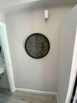 a clock on a white wall in a room at Spasimo Boutique in Palermo
