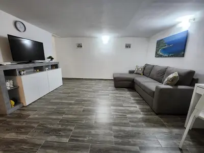 a living room with a couch and a flat screen tv at Don Vito's Home, DsG2 Short Lets, 250 mt Metrò in Palermo